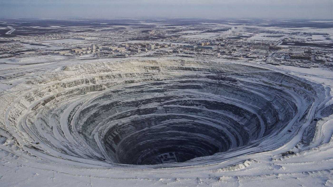 Aerial view of the vast terraced pit of the Mirny diamond mine in snowy Siberia