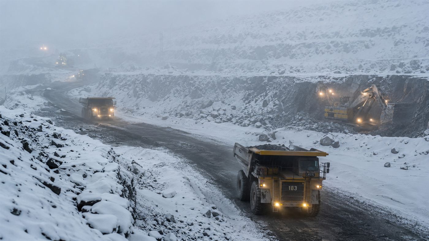 Trucks working the terraced ledges of the Mirny diamond mine in deep Siberian snow