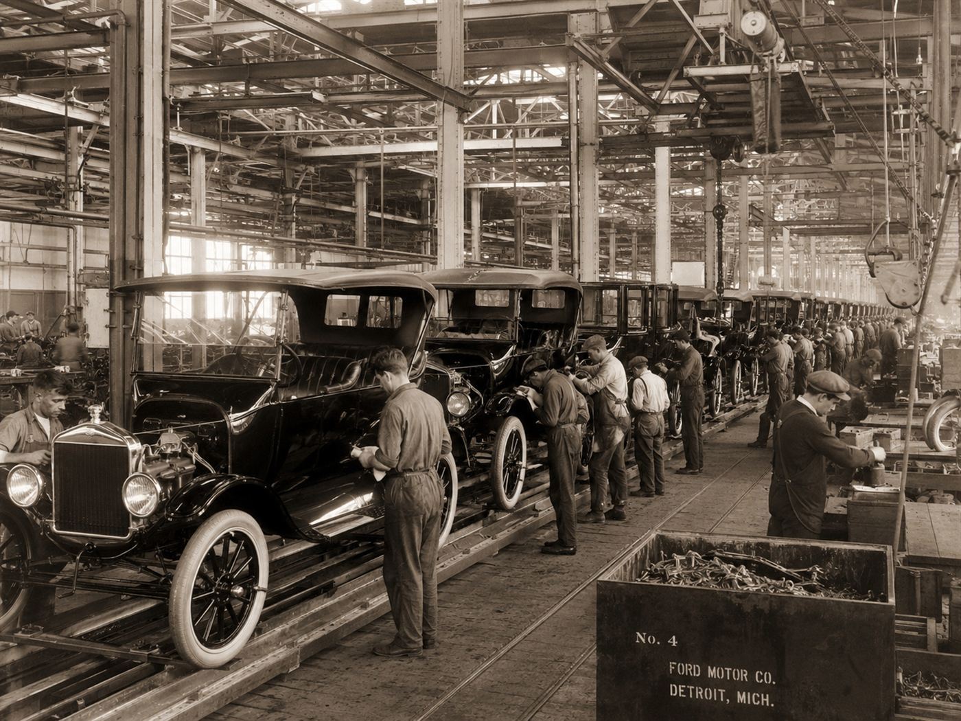 A 1910s Ford Model T assembly line of gasoline cars, the mass production that beat the Edison Ford electric car