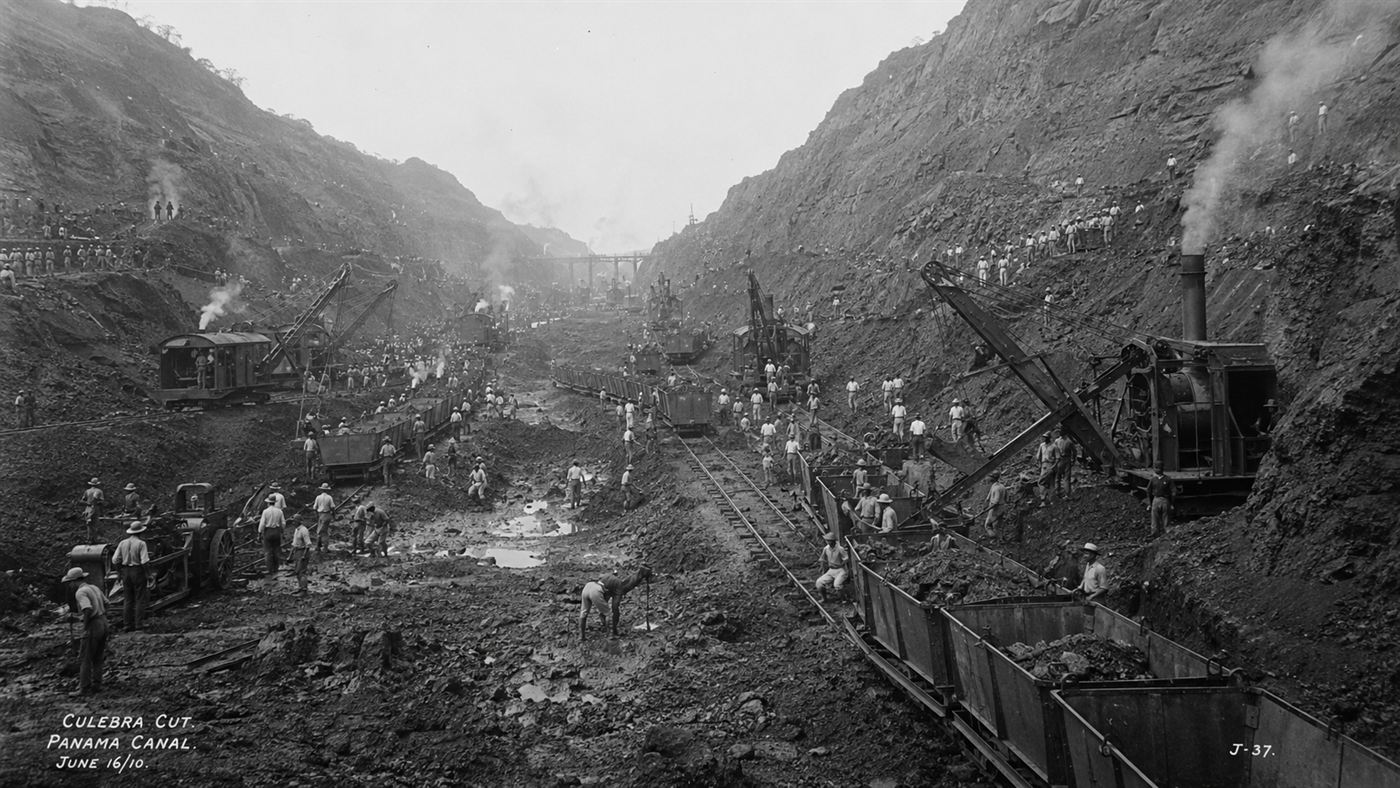 The vast Panama Canal construction site at the Culebra Cut, with steam shovels and railways carving through the hills
