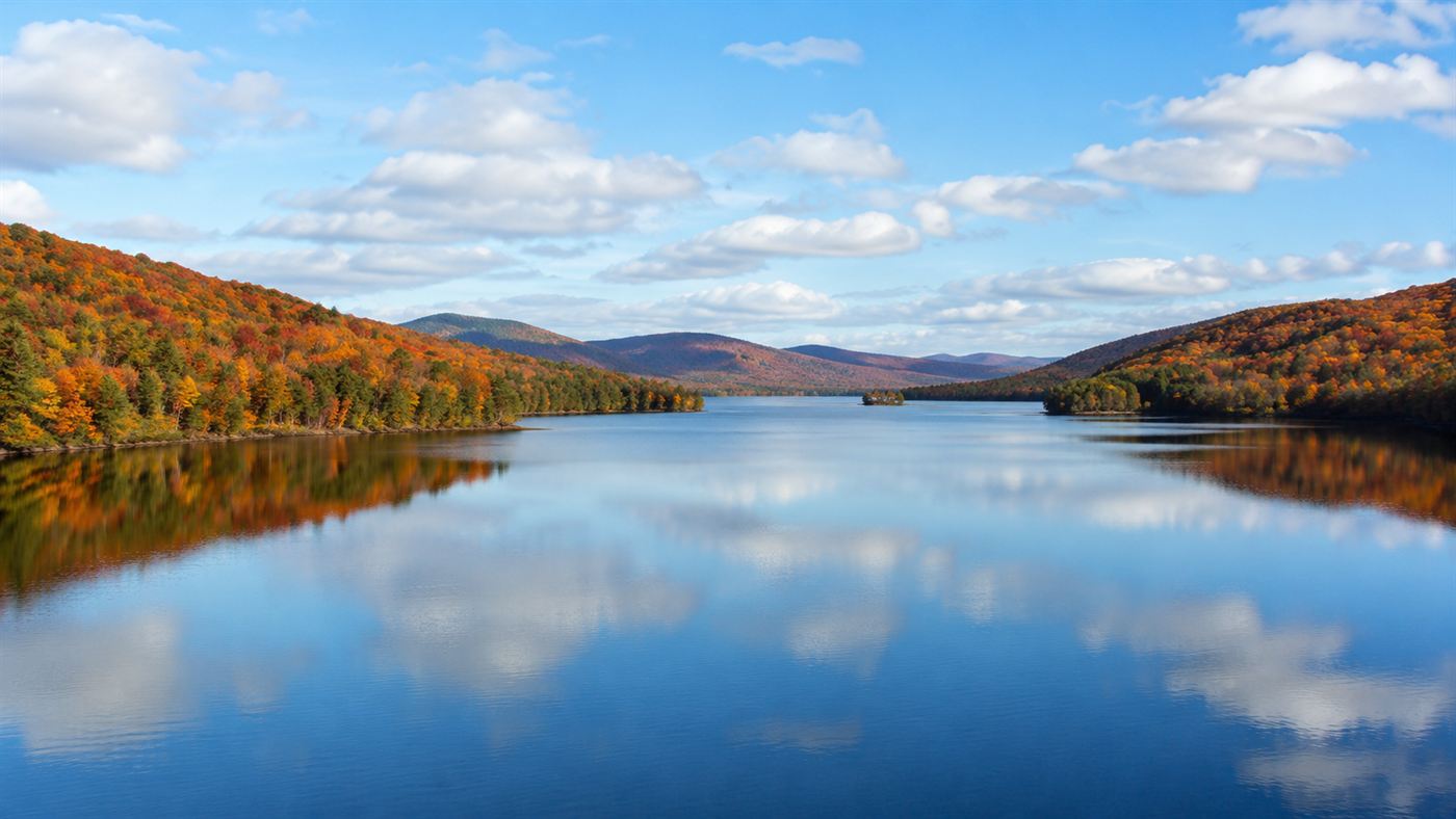 The calm surface of the Quabbin Reservoir over the drowned Swift River Valley in autumn