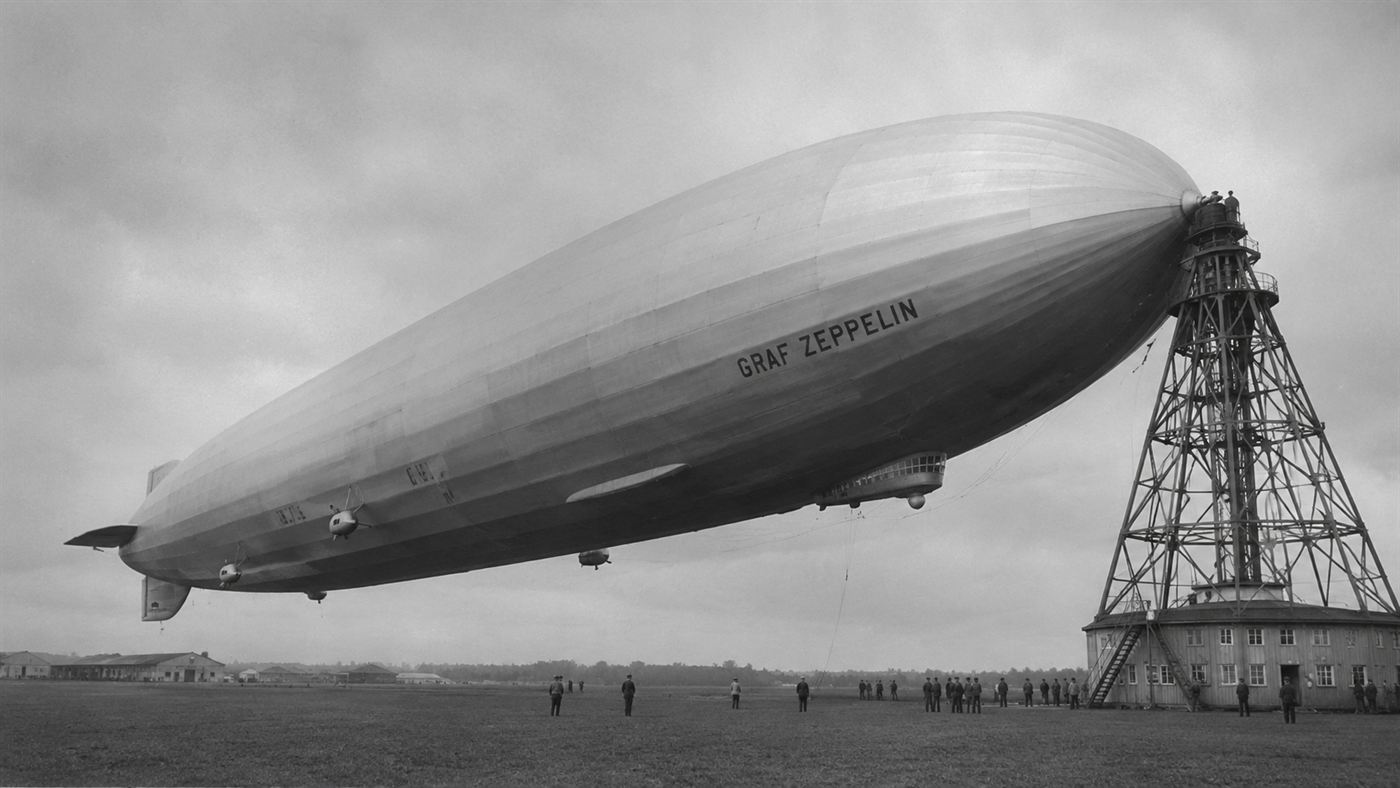 The huge silver British R101 airship moored to its mast above Cardington in 1930