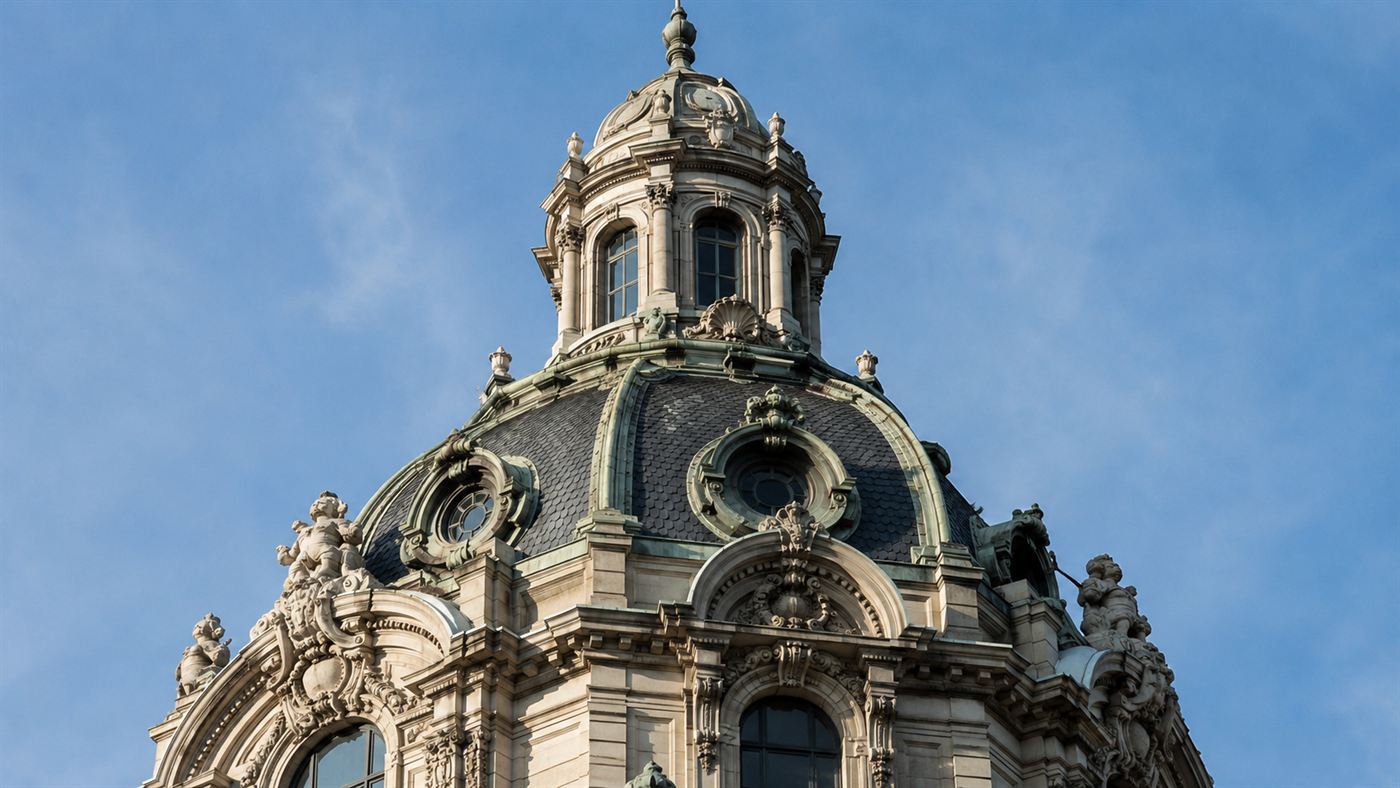 A detailed view of the ornate domed lantern and mansard crown at the very top of the Singer Building tower