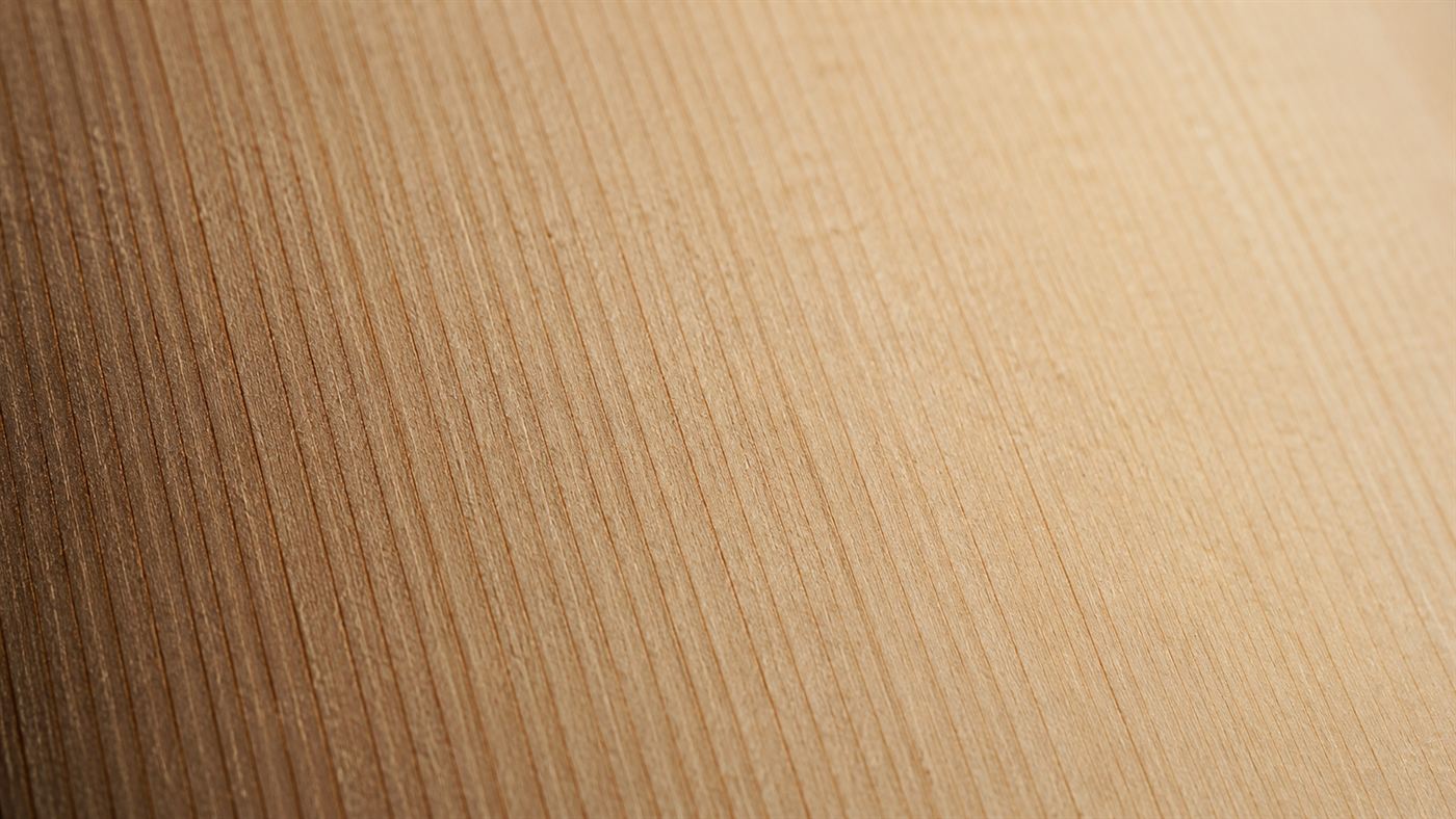 An extreme close-up of the fine straight grain of a piece of spruce tonewood used for making violins
