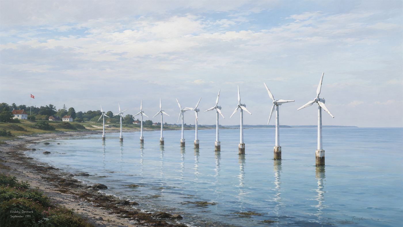 A row of small white 1990s wind turbines standing in calm shallow blue sea near a low green Danish coastline under a soft sky