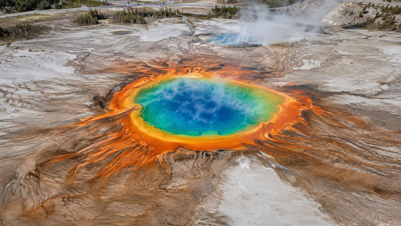 A steaming Yellowstone hot spring ringed with thermophile mats, the source of Thermus aquaticus and its Taq polymerase enzyme