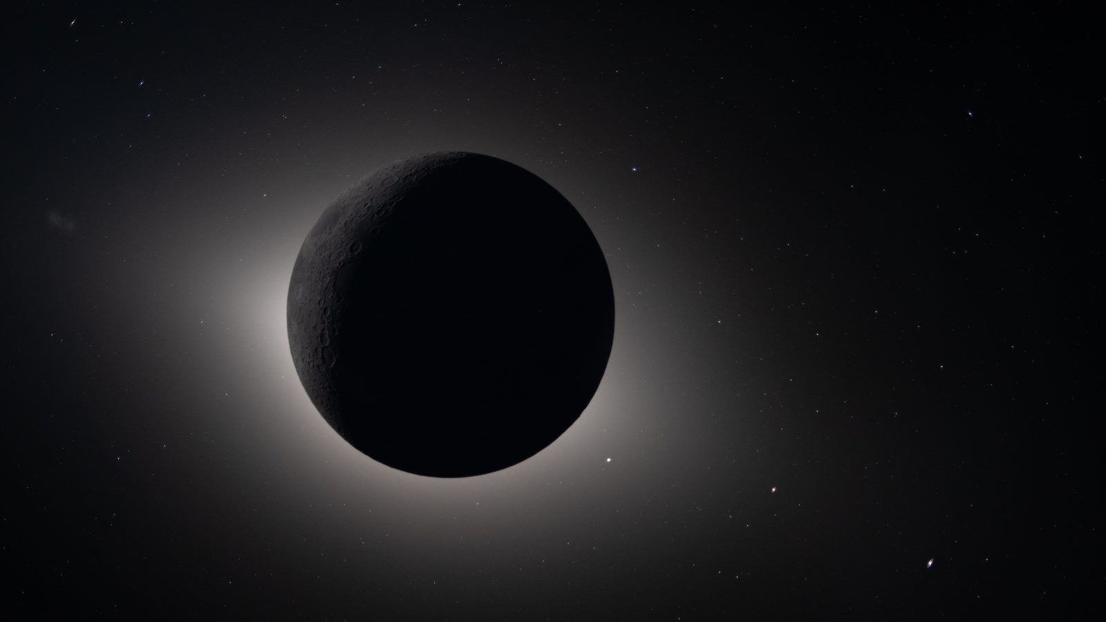Disco escuro da Lua cobrindo o Sol, com a coroa solar brilhando em volta, em uma das imagens inéditas da Lua feitas pela Artemis 2