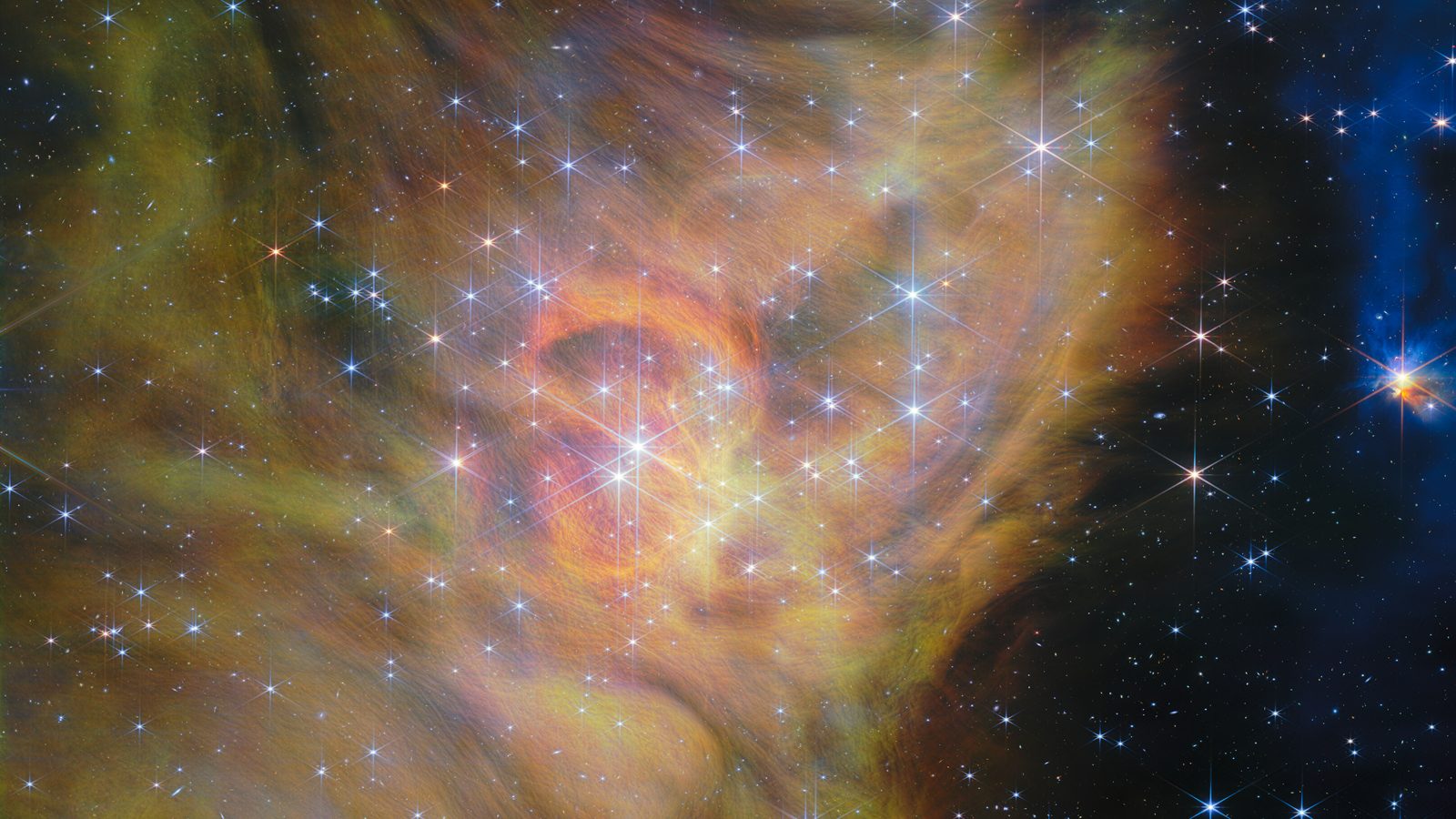 Nebulosa dourada e laranja de IC 348 com estrelas de pontas difratadas, região onde o Webb achou anãs marrons de 2 massas de Júpiter